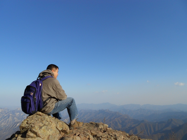 a view of Woody's back on the ridge top of Baihua Mountain